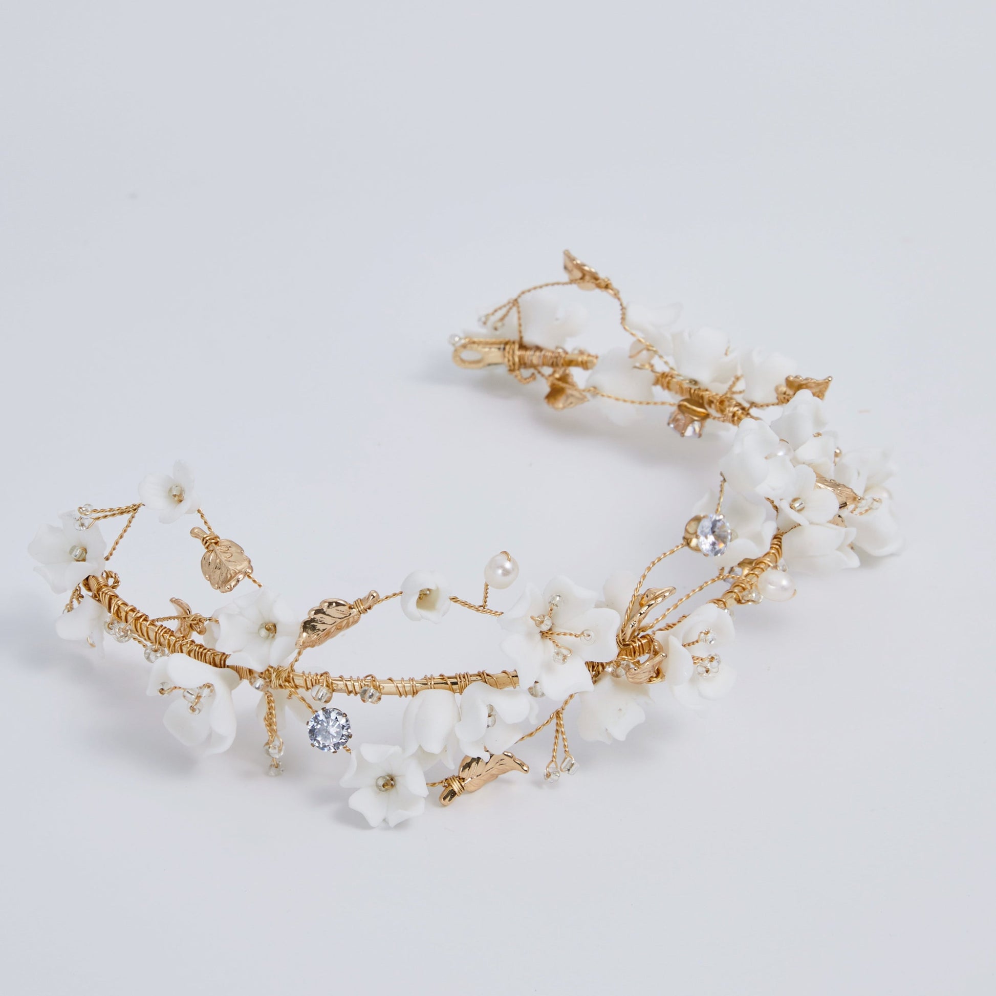 This beautifully hand-sculpted clay & pearl crown features individually crafted cherry blossom flowers, dainty freshwater pearls, and crystals. The result is a full, textured headband that makes a statement while remaining incredibly feminine.
