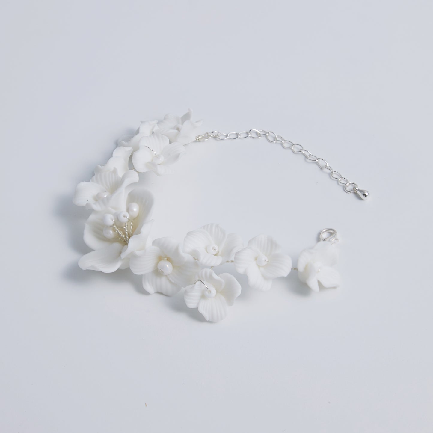 This beautifully crafted porcelain bracelet features individually carved flowers and an impressively full and intricate design.