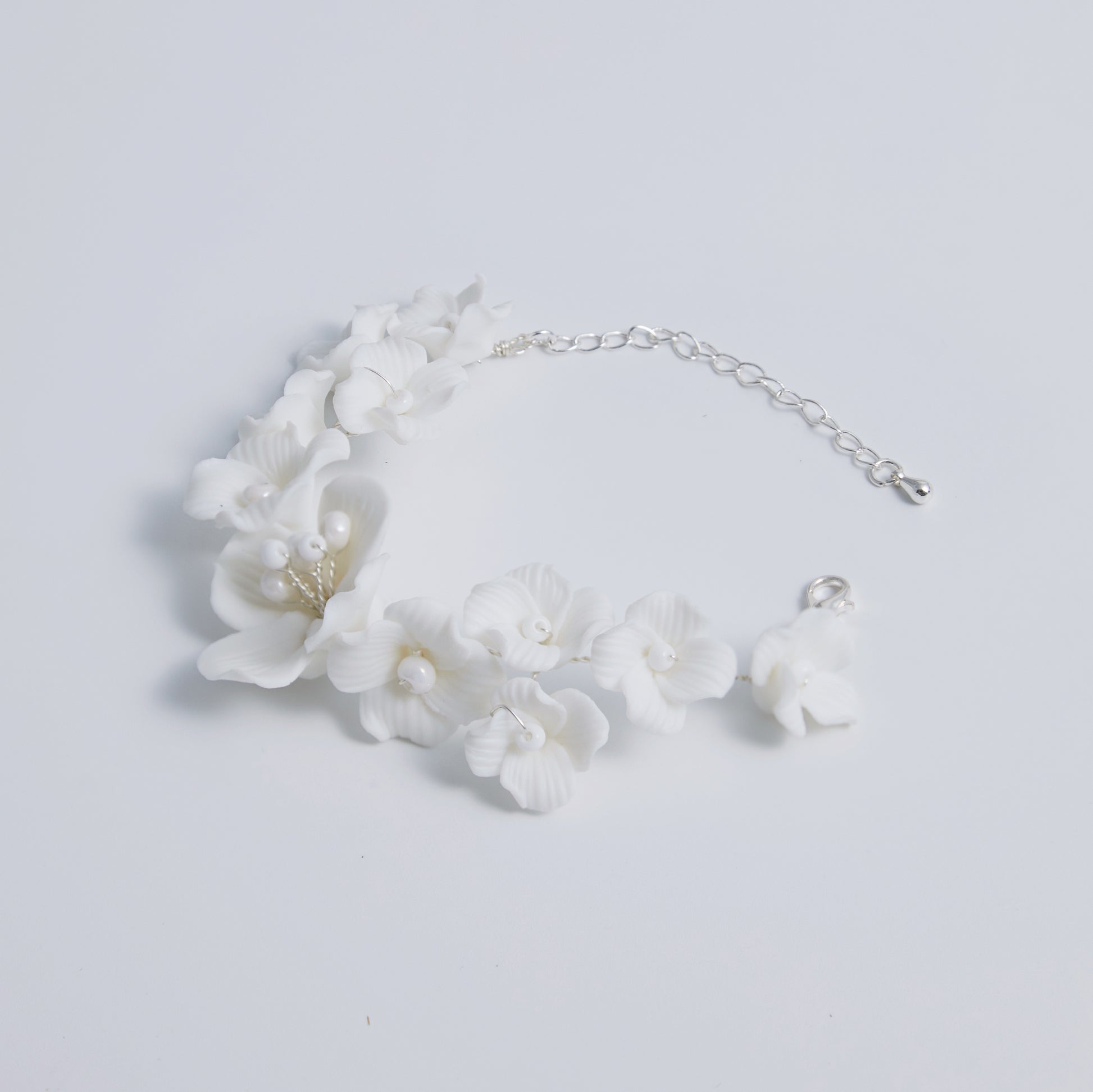 This beautifully crafted porcelain bracelet features individually carved flowers and an impressively full and intricate design.