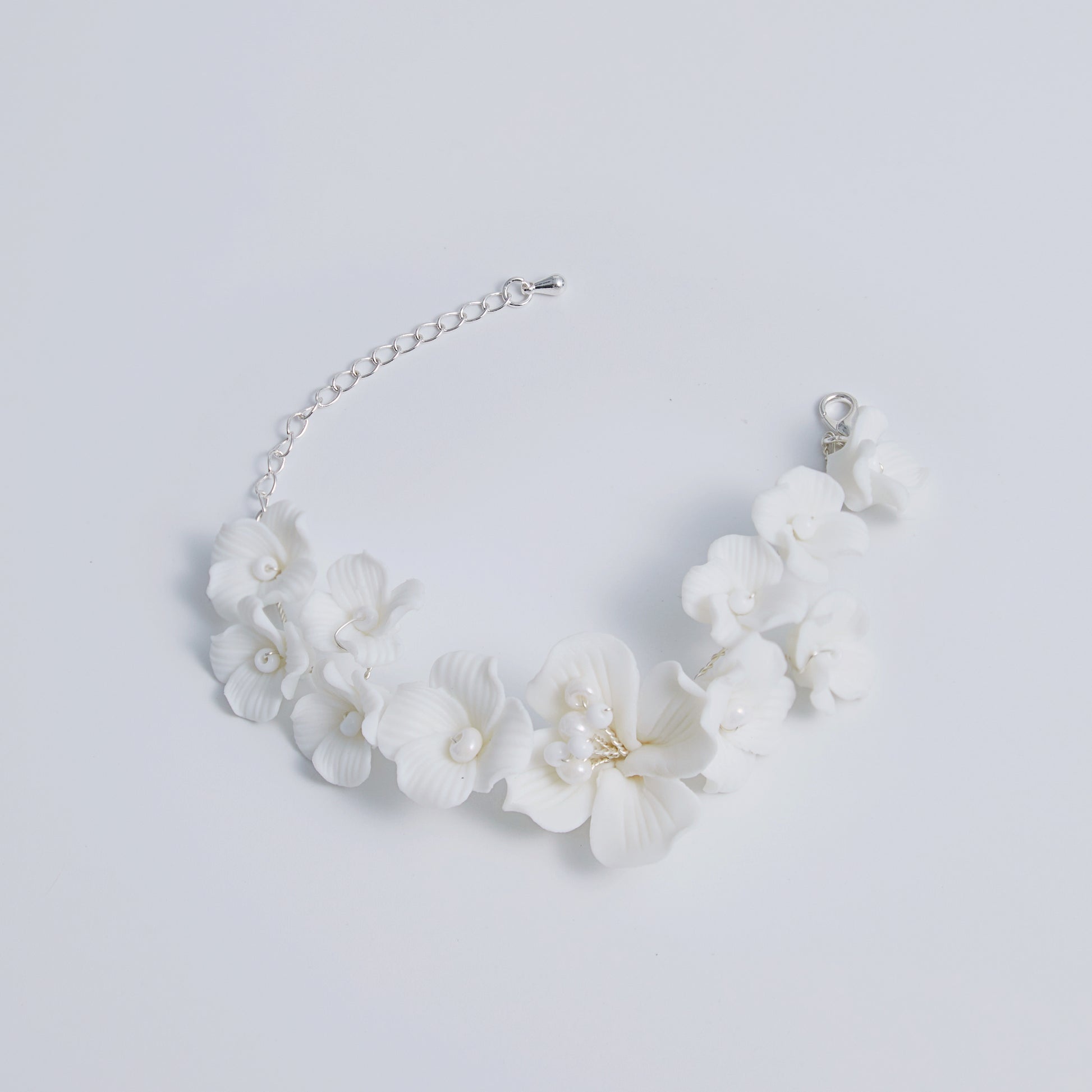 This beautifully crafted porcelain bracelet features individually carved flowers and an impressively full and intricate design.
