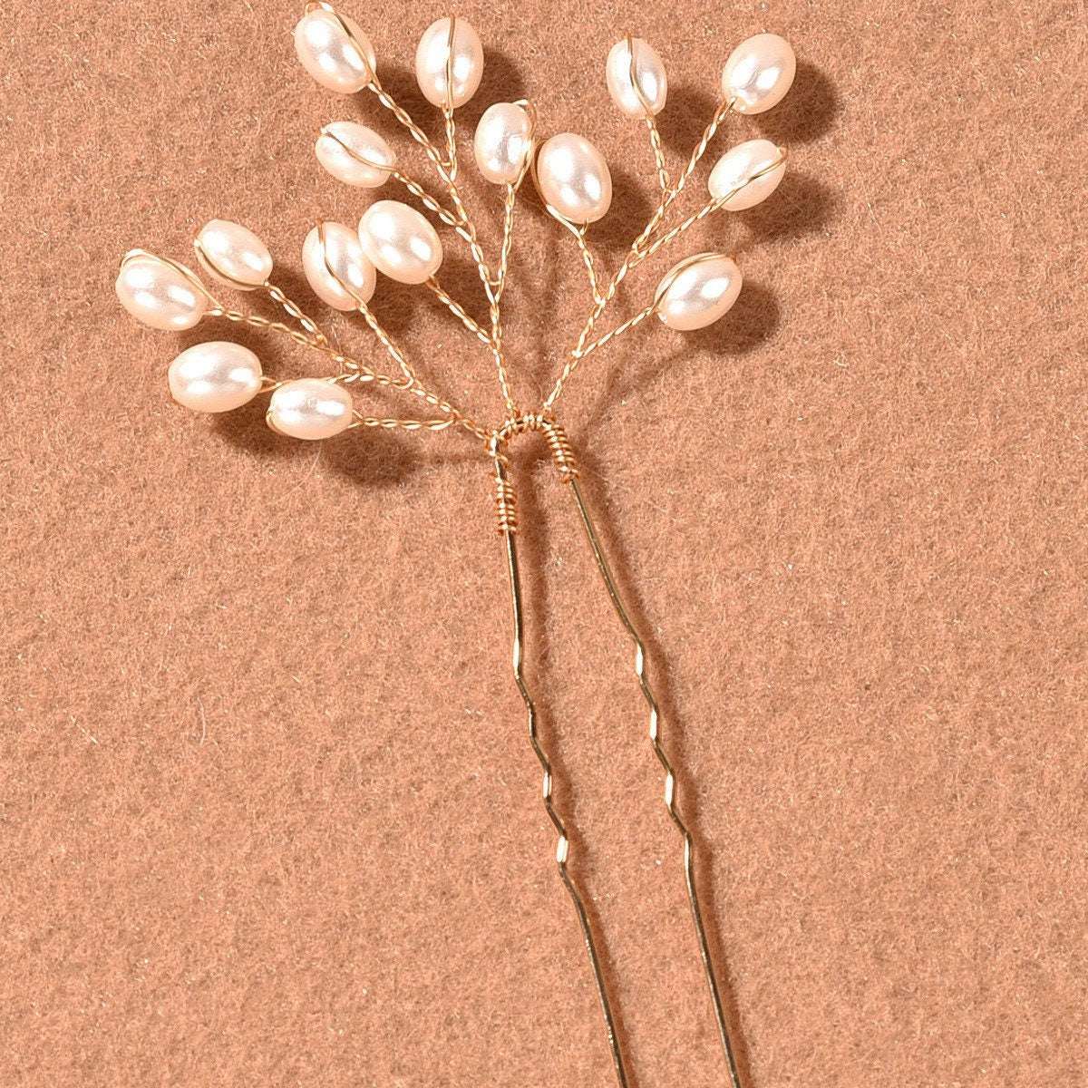 Detail of the lustrous pearls on the delicate branch hair pin