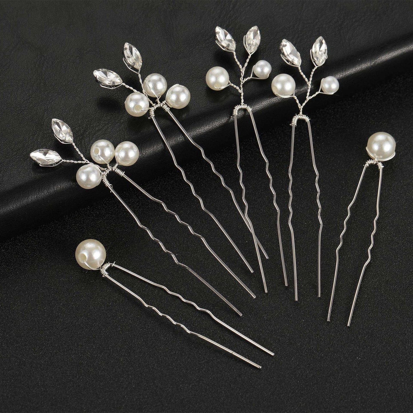 Set of 6 silver bridal hair pins with pearls and crystals on a black background