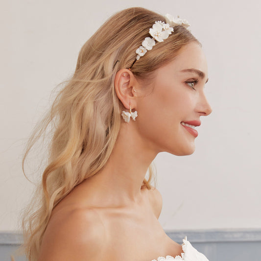 these flower bridal earrings  feature two delicate white clay flowers adorned with freshwater pearls and crystal-embellished French hooks that create a brilliant sparkle with every move.