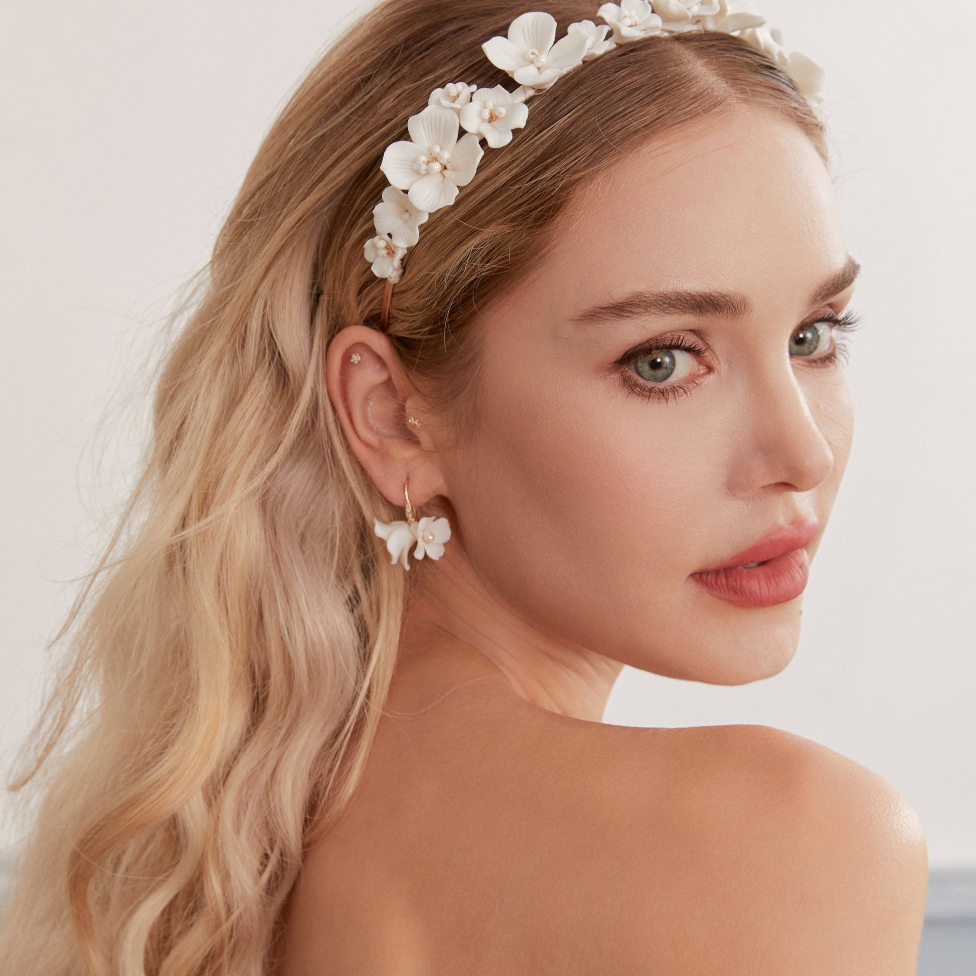 these flower bridal earrings  feature two delicate white clay flowers adorned with freshwater pearls and crystal-embellished French hooks that create a brilliant sparkle with every move.