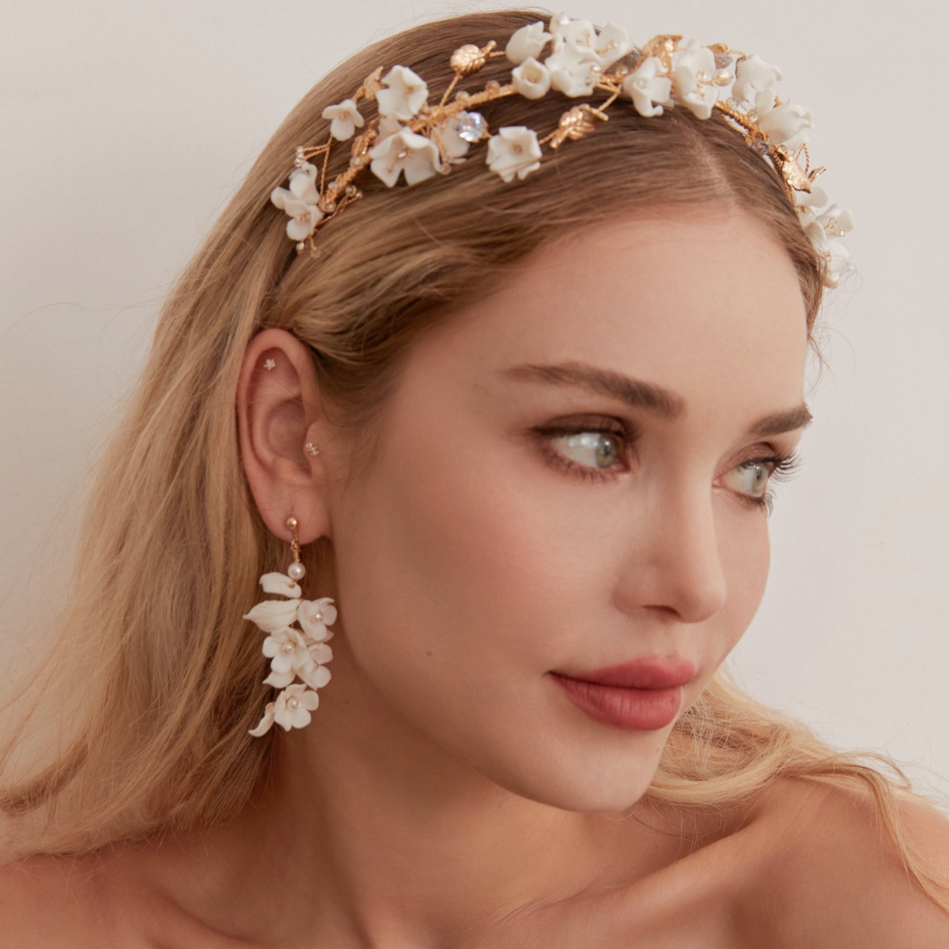 This beautifully hand-sculpted clay & pearl crown features individually crafted cherry blossom flowers, dainty freshwater pearls, and crystals. The result is a full, textured headband that makes a statement while remaining incredibly feminine.