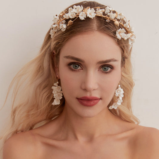 This beautifully hand-sculpted clay & pearl crown features individually crafted cherry blossom flowers, dainty freshwater pearls, and crystals. The result is a full, textured headband that makes a statement while remaining incredibly feminine.