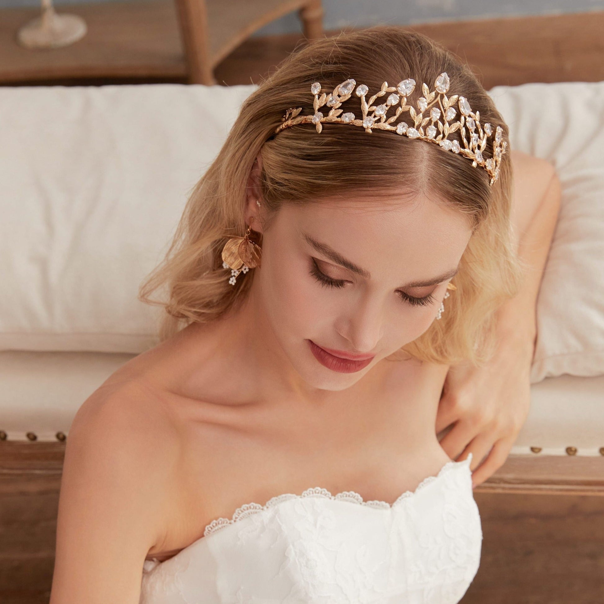 Victoria | Gold Crystal Bridal Crown Tiara - Handcrafted with attention to detail, this unique crown features delicate gold metal leaves intricately arranged alongside an array of dazzling rhinestone flowers in various sizes. The combination of gold and crystals creates a vintage-inspired woodland feel.