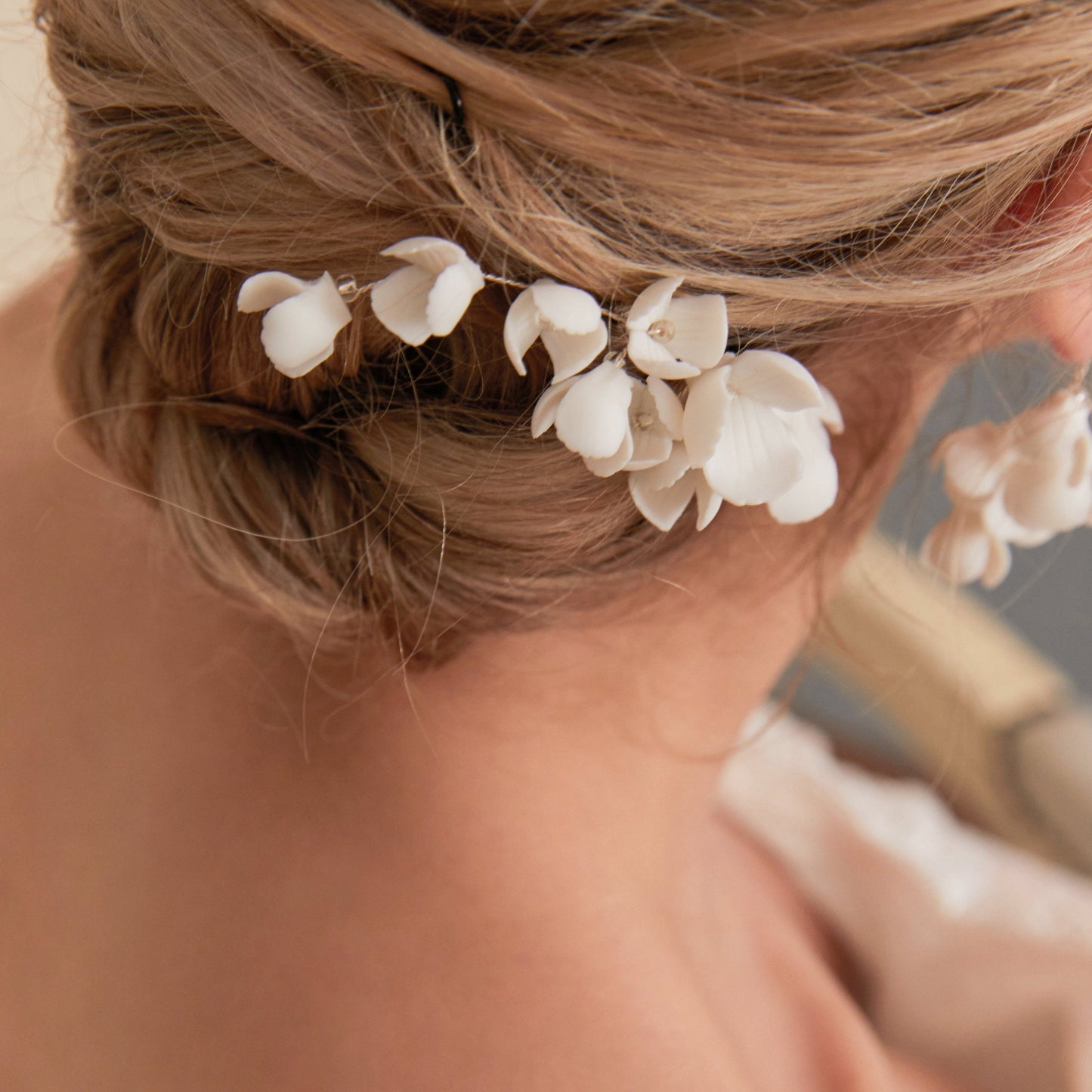 This hair comb is perfect for brides who want a modest and timeless look. It features delicate clay flowers and small beads that are arranged carefully to create a romantic and classic design.