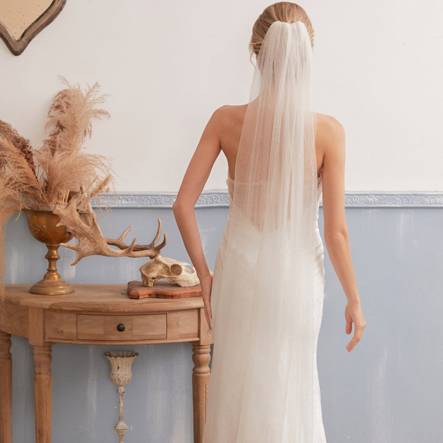 Luxurious single-layer cathedral wedding veil crafted from delicate sparkle glitter tulle. With an ivory base (also available in white and champagne), it features a simple cut edge for an elegant and timeless style that complements any bridal look.  At 3 meters long, this veil is the perfect bridal accessory to enhance any wedding dress. Offering a subtle sparkle without any fuss, it adds a touch of glamour to your special day.
