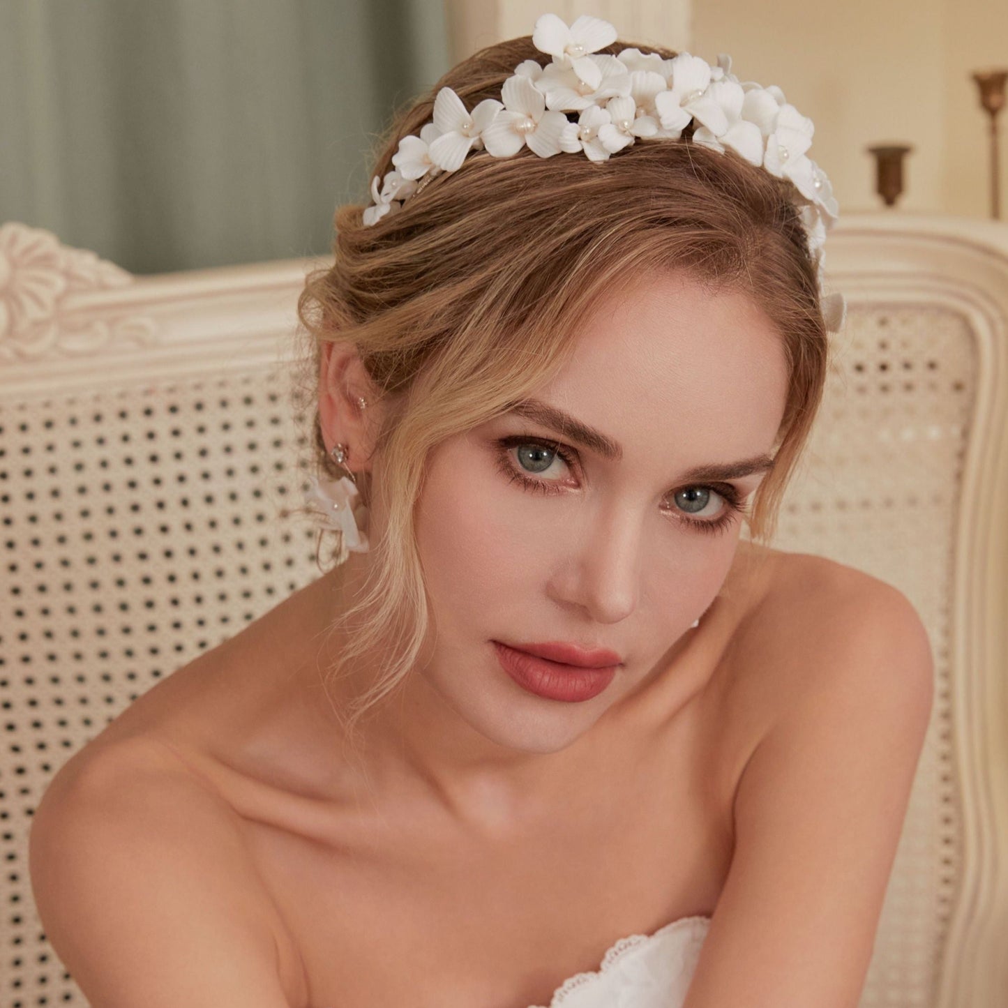 A gloriously romantic hand-sculpted porcelain bridal crown. Made with an arrangement of individually crafted flowers and dainty pearls. This full and textured headband makes a statement but yet still feels incredibly feminine.
