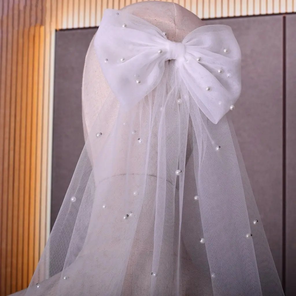 Close-up of the handmade tulle bow with freshwater pearls in a bride's hair