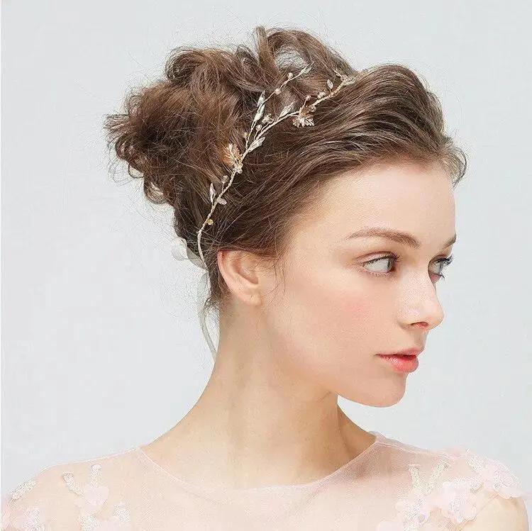 Profile of a model wearing a handmade gold leaf bridal hair accessory