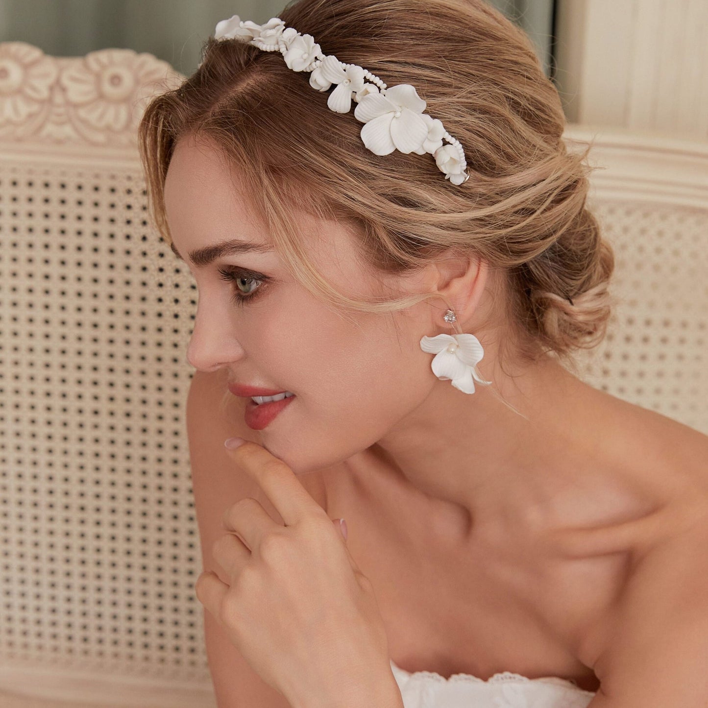 Skillfully handcrafted, these flower bridal earrings are the perfect complement to our signature porcelain headpieces. Each earring is exquisitely made by hand, featuring two delicate white clay flowers adorned with freshwater pearls.