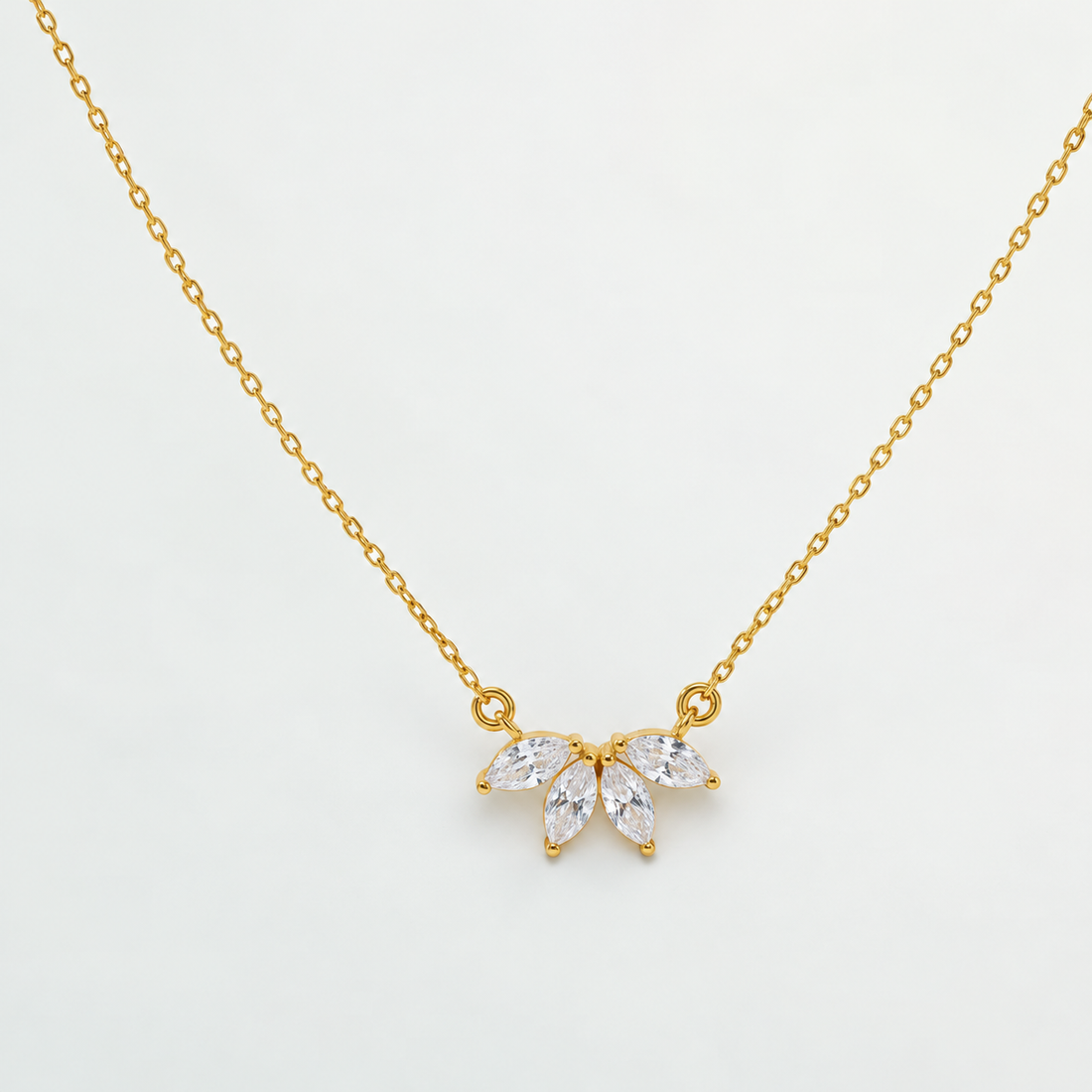 Gold-coloured Marquise Flower Petal CZ Necklace displayed on ivory satin, showing its delicate floral pendant and fine chain