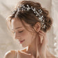 Bride wearing silver pearl crystal hair vine woven through elegant wedding updo hairstyle