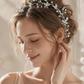Bride wearing silver pearl crystal hair vine woven through elegant wedding updo hairstyle
