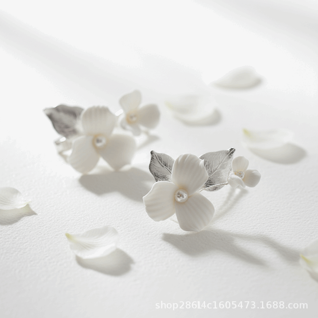 Close-up of silver-plated porcelain blossom and leaf hair pin for weddings