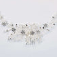 Sparkly rhinestone flower hair comb on a black background