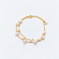 Gold double-strand pearl bridal bracelet arranged in a circular shape