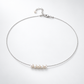 Silver-plated natural pearl necklace laid flat, with five pearls centred on the chain