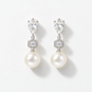 Pair of silver pear-shaped crystal and pearl drop earrings, front view