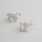 Close-up of silver-plated porcelain blossom and leaf hair pin for weddings