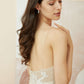 Bride looking down, showing the natural drape of the silver leaf drop earrings