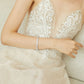 Bride wearing the minimalist teardrop crystal bridal earrings with a wedding dress