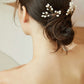 Back view of a bride with a romantic updo and pearl hair accessories
