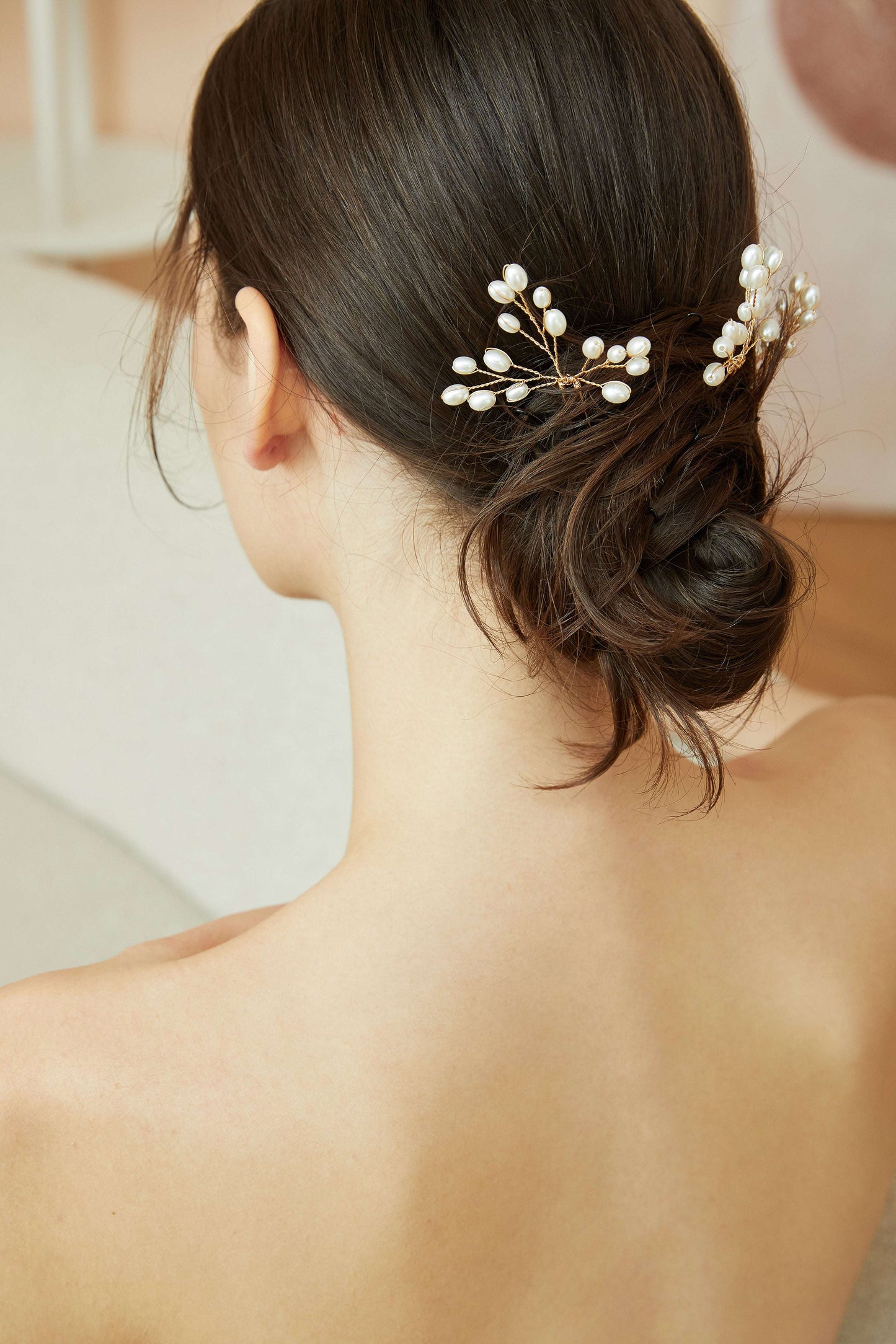 Back view of a bride with a romantic updo and pearl hair accessories