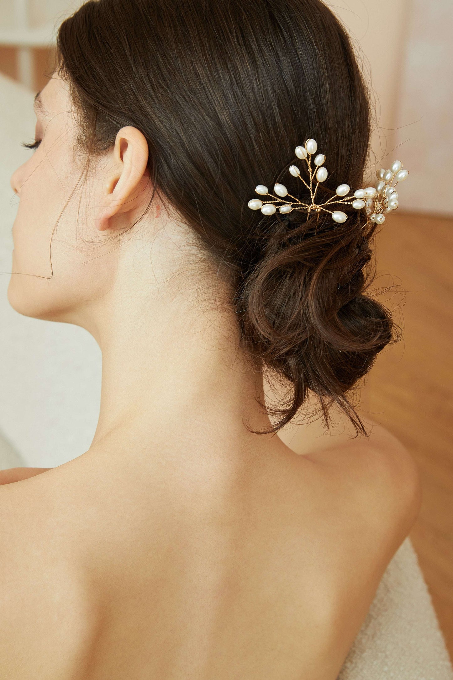 Side view of a bride wearing a pearl branch hair pin