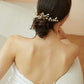 Model wearing delicate pearl hair pins in an elegant updo