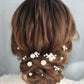 Close-up of a bride wearing a minimalist silver pearl hair pin in an elegant updo