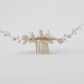Gold-tone metal comb base of white porcelain bridal hair piece, secure grip design