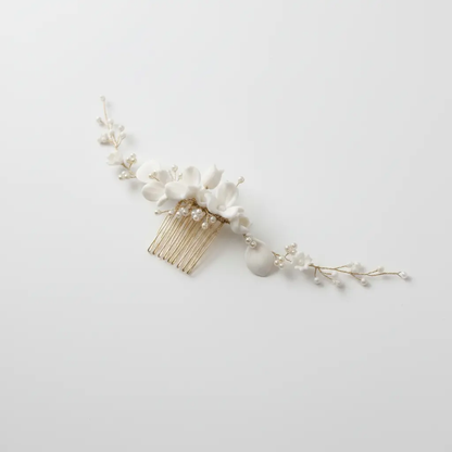 White porcelain flower bridal hair comb with pearls, front view on white background