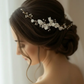 Bridal side profile with white porcelain flower pearl comb in low bun hairstyle
