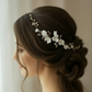 Bridal side profile with white porcelain flower pearl comb in low bun hairstyle