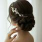 Bridal side profile with white porcelain flower pearl comb in low bun hairstyle
