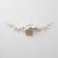 White porcelain flower bridal hair comb with pearls, front view on white background