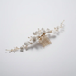 White porcelain flower bridal hair comb with pearls, front view on white background