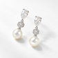 Silver crystal and pearl drop earrings photographed at an angle