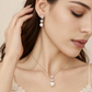 Bride touching her hair while wearing crystal and pearl bridal jewellery