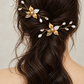 Two gold-plated pearl and CZ leaf bridal hair combs worn in a brown half-up hairstyle, rear view