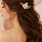 Bride wearing the white ceramic flower and crystal bridal hair comb in a half-up hairstyle, side view.