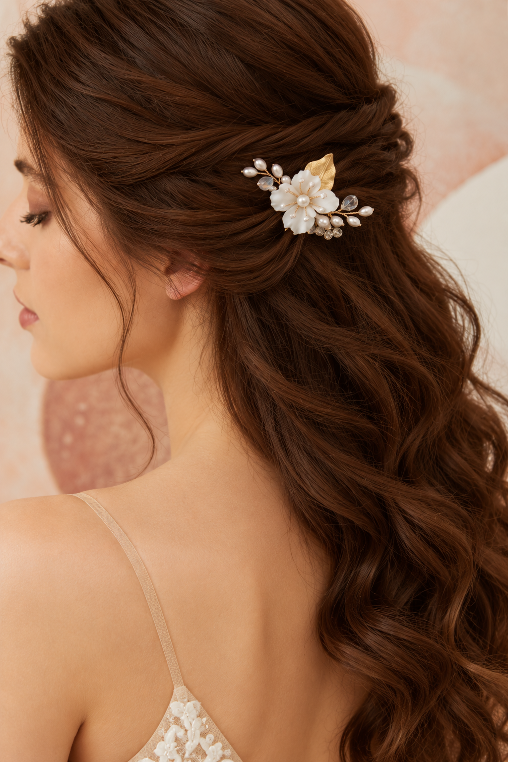 Bride wearing the white ceramic flower and crystal bridal hair comb in a half-up hairstyle, side view.