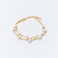 Gold pearl bracelet showing naturally irregular pearls on two fine chains
