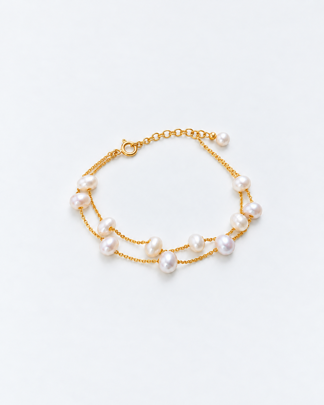 Gold pearl bracelet showing naturally irregular pearls on two fine chains