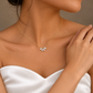 Three-quarter view of a bride wearing a marquise flower petal necklace