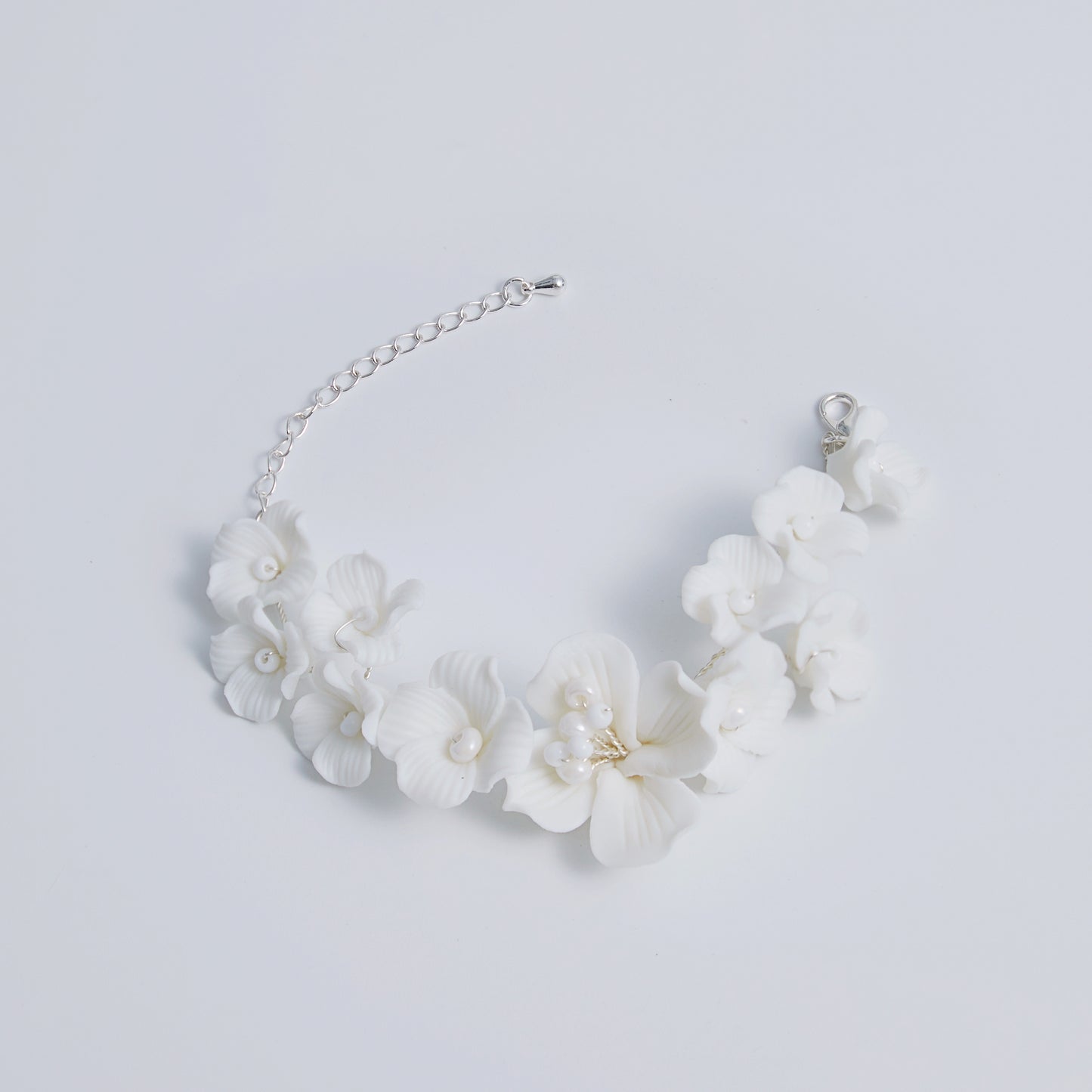 This beautifully crafted porcelain bracelet features individually carved flowers and an impressively full and intricate design.