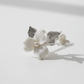 Close-up of silver-plated porcelain blossom and leaf hair pin for weddings